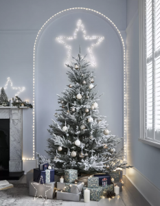 Frosted Christmas tree with silver and white baubles and big light star, with Christmas presents